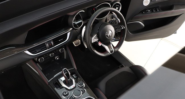 Front seats and dashboard of a Stelvio QV from the sunroof
